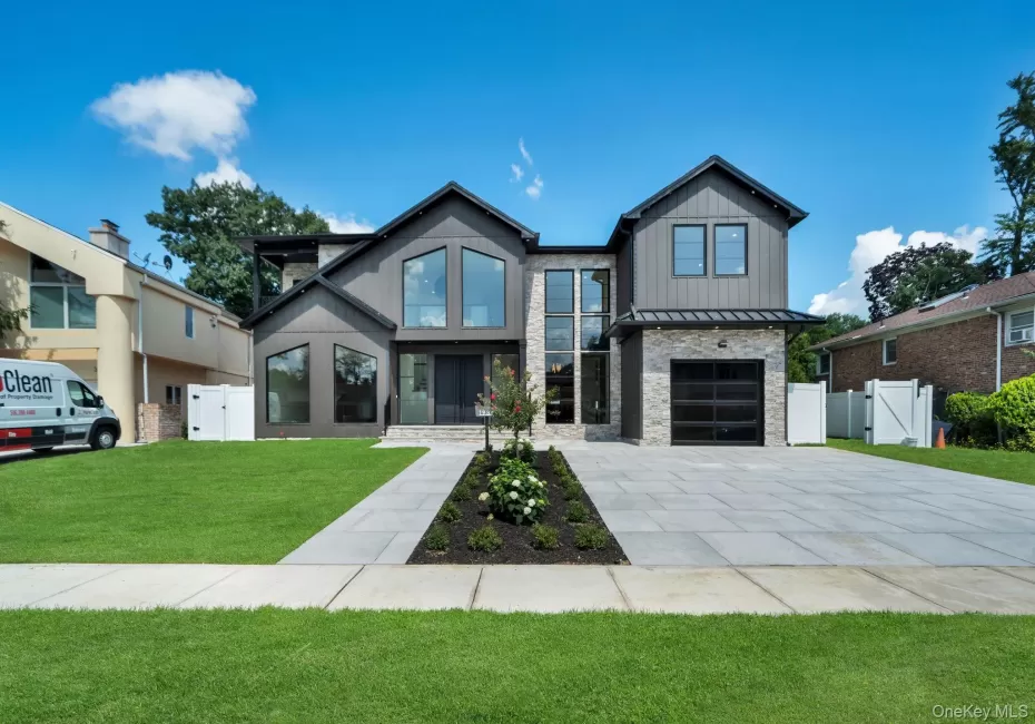 Contemporary exterior featuring dark vertical siding and stone accents Contemporary exterior featuring dark vertical siding and stone accents