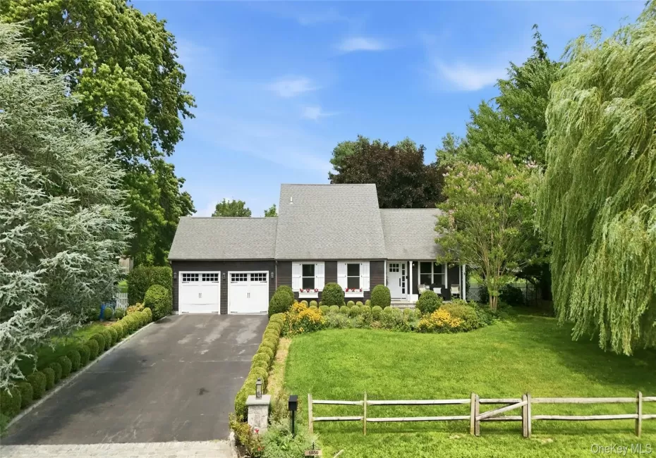 Exterior featuring a dark siding, white shutter accents, a gray shingle roof, and a two-car garage with white doors Exterior featuring a dark siding, white shutter accents, a gray shingle roof, and a two-car garage with white doors