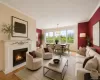 Spacious living area featuring a decorative fireplace with a mantel, crown molding, and wood-finish flooring Spacious living area featuring a decorative fireplace with a mantel, crown molding, and wood-finish flooring