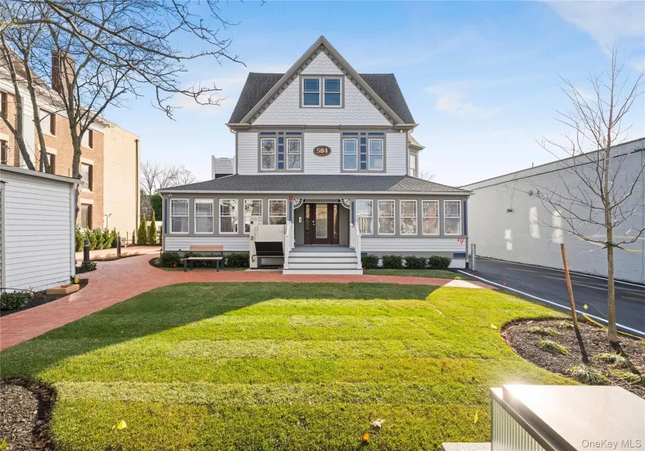Victorian home featuring a shingled roof and a front yard Victorian home featuring a shingled roof and a front yard