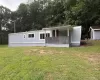 Manufactured / mobile home featuring a front yard and a covered porch Manufactured / mobile home featuring a front yard and a covered porch
