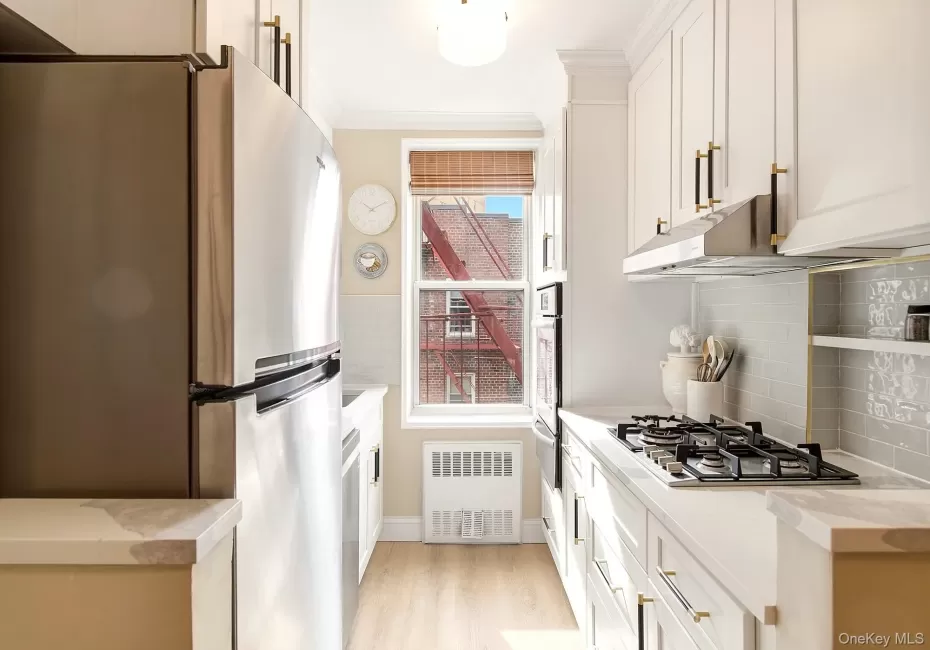 Fully renovated windowed kitchen with new shaker style cabinets, quartz counter tops and stainless steel appliances Fully renovated windowed kitchen with new shaker style cabinets, quartz counter tops and stainless steel appliances