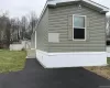 View of side of home featuring an outbuilding and a yard View of side of home featuring an outbuilding and a yard