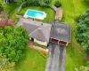 Property featuring a shingle roof, attached two-car garage, and a paved driveway Property featuring a shingle roof, attached two-car garage, and a paved driveway
