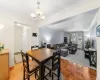 Dining room featuring light parquet floors, an inviting chandelier, and crown molding Dining room featuring light parquet floors, an inviting chandelier, and crown molding