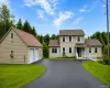 Expansive asphalt driveway leading to a two-story residence and a detached two-car garage Expansive asphalt driveway leading to a two-story residence and a detached two-car garage