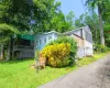 View of front facade featuring a front lawn and a deck View of front facade featuring a front lawn and a deck