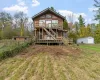 Back of property with an outdoor structure, a deck, and stairs Back of property with an outdoor structure, a deck, and stairs