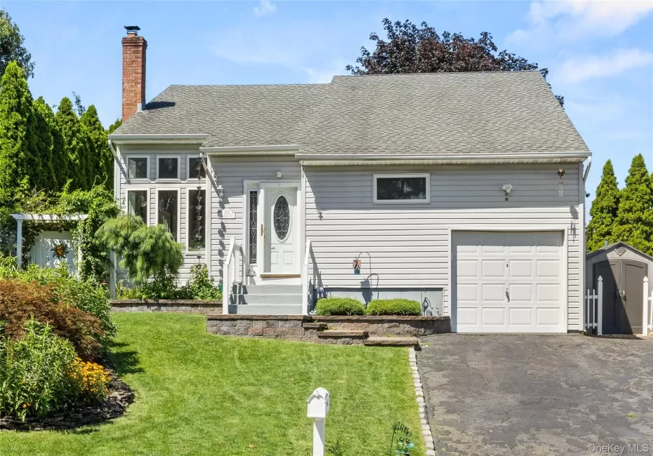 Exterior featuring light gray siding, a single-car garage Exterior featuring light gray siding, a single-car garage