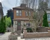 Stucco and stone facade home featuring a prominent bay window Stucco and stone facade home featuring a prominent bay window