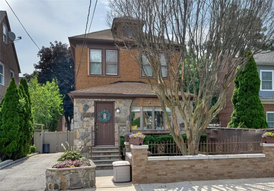 Stucco and stone facade home featuring a prominent bay window Stucco and stone facade home featuring a prominent bay window