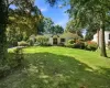 Expansive front lawn with mature trees and established landscaping Expansive front lawn with mature trees and established landscaping